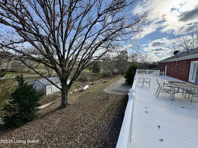 view of yard with a deck and outdoor dining space
