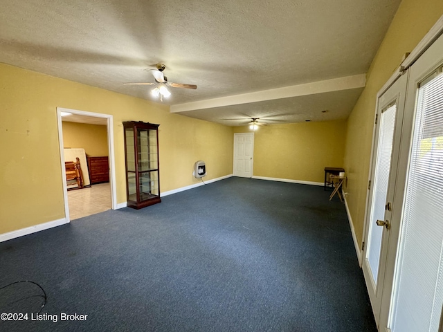 empty room with ceiling fan, a textured ceiling, baseboards, and french doors