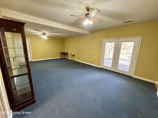 empty room with french doors, a textured ceiling, baseboards, visible vents, and ceiling fan