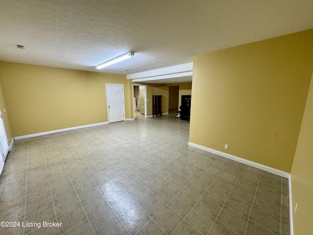 spare room with baseboards, visible vents, and tile patterned floors