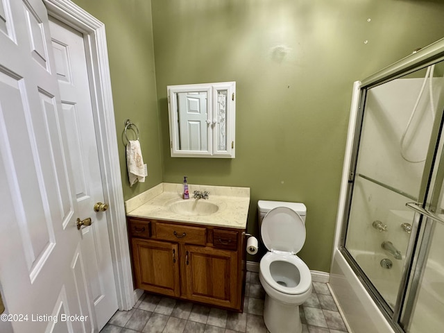 full bath with toilet, baseboards, vanity, and shower / bath combination with glass door