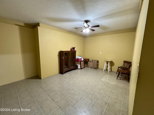 empty room featuring ceiling fan and tile patterned floors