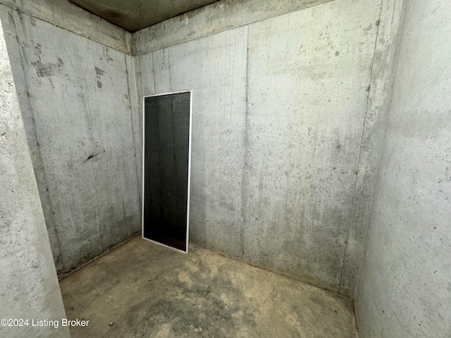 spare room featuring unfinished concrete floors