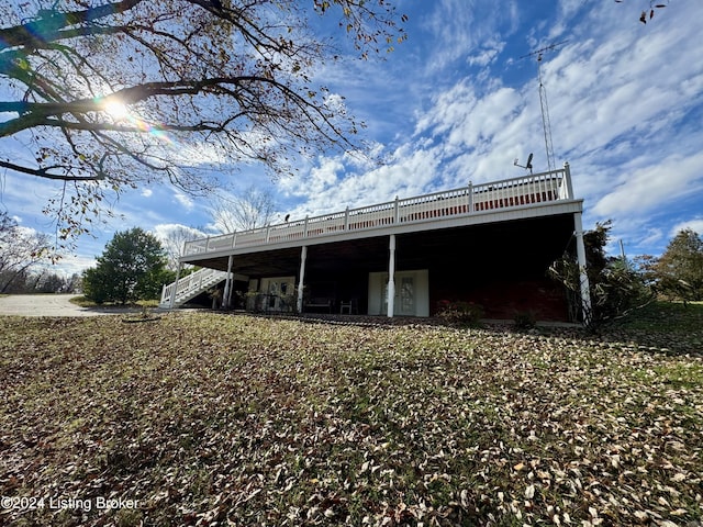 back of house featuring stairway and a wooden deck