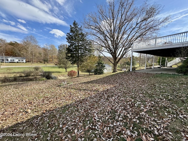 view of yard with a deck and a carport