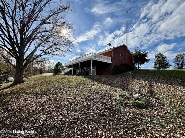 back of property with brick siding and a deck