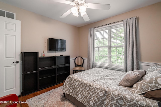 13216 Willow Forest Dr, Louisville, KY 40245 - bedroom featuring wood finished floors, multiple windows, a wainscoted wall, and ceiling fan