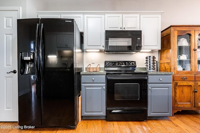 13216 Willow Forest Dr, Louisville, KY 40245 - kitchen featuring black appliances, gray cabinetry, light wood-style floors, white cabinets, and glass insert cabinets
