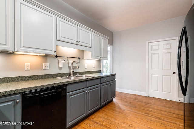 13216 Willow Forest Dr, Louisville, KY 40245 - kitchen featuring black appliances, a sink, dark countertops, gray cabinetry, and light wood-style flooring