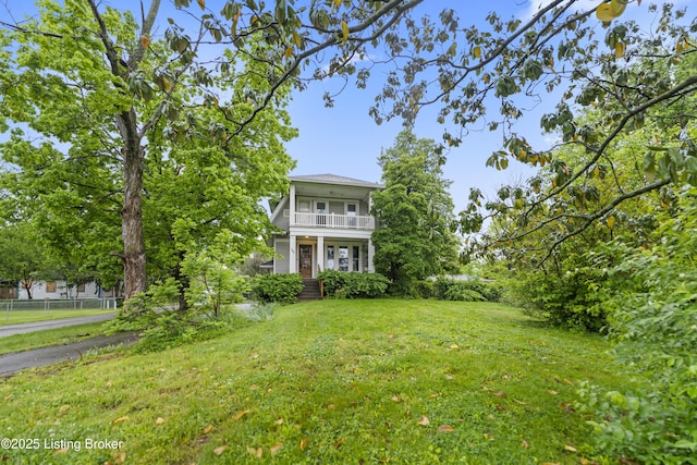 1412 Bluegrass Ave, Louisville, KY 40215 - view of front of property with covered porch, fence, a front yard, and a balcony