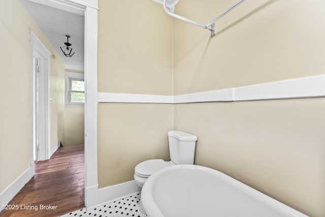 1412 Bluegrass Ave, Louisville, KY 40215 - bathroom featuring toilet, baseboards, and wood finished floors
