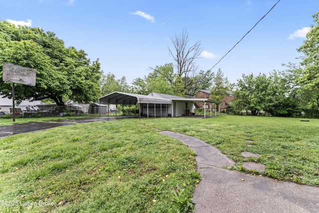 1412 Bluegrass Ave, Louisville, KY 40215 - view of yard with a carport and aphalt driveway