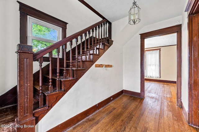 1412 Bluegrass Ave, Louisville, KY 40215 - stairway with baseboards, hardwood / wood-style floors, and plenty of natural light