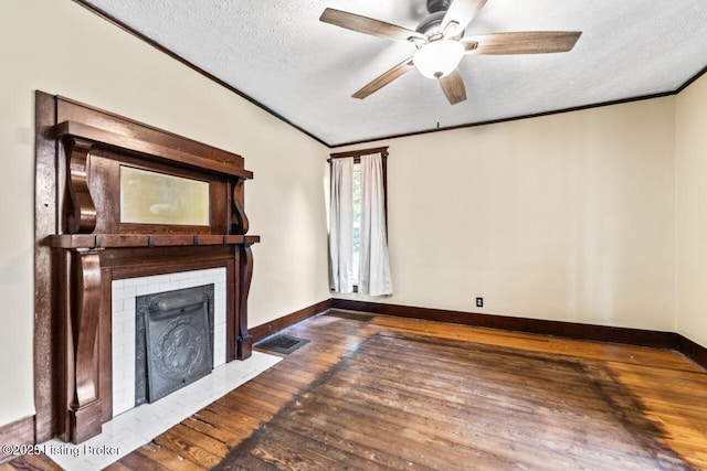 1412 Bluegrass Ave, Louisville, KY 40215 - unfurnished living room featuring hardwood / wood-style flooring, ornamental molding, a textured ceiling, baseboards, and a fireplace with flush hearth