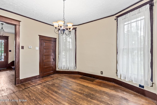 1412 Bluegrass Ave, Louisville, KY 40215 - unfurnished dining area featuring an inviting chandelier, a textured ceiling, visible vents, baseboards, and dark wood-type flooring
