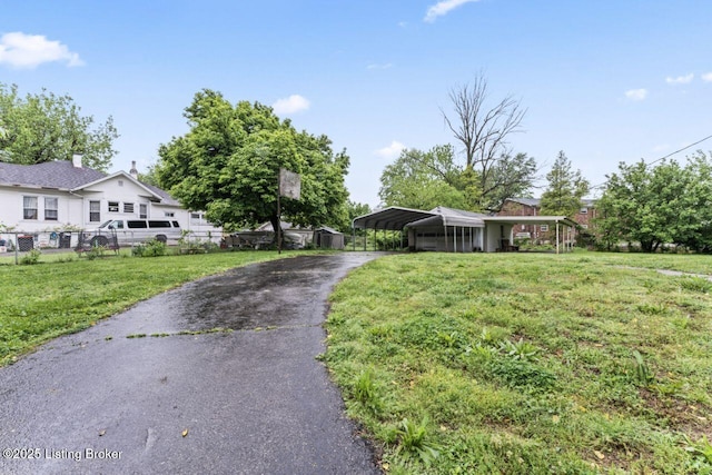 1412 Bluegrass Ave, Louisville, KY 40215 - view of front facade featuring a front yard, aphalt driveway, fence, and a carport