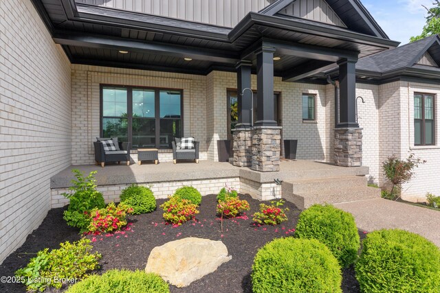 entrance to property with board and batten siding and brick siding