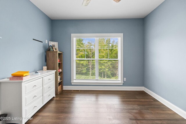 bedroom with multiple windows, baseboards, and dark wood-style floors