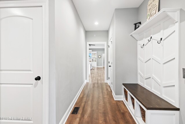 mudroom with dark wood-style floors, baseboards, and recessed lighting