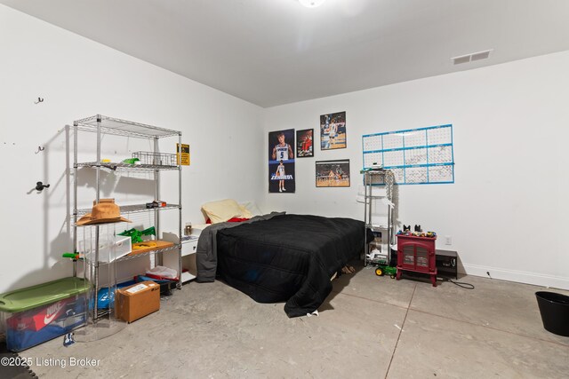 bedroom featuring unfinished concrete floors and baseboards