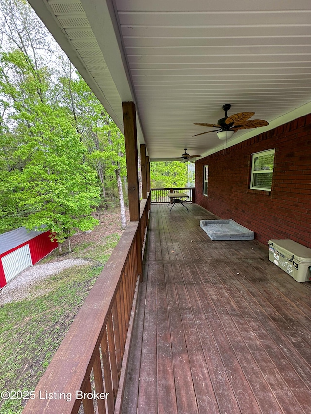 deck with ceiling fan and an outbuilding