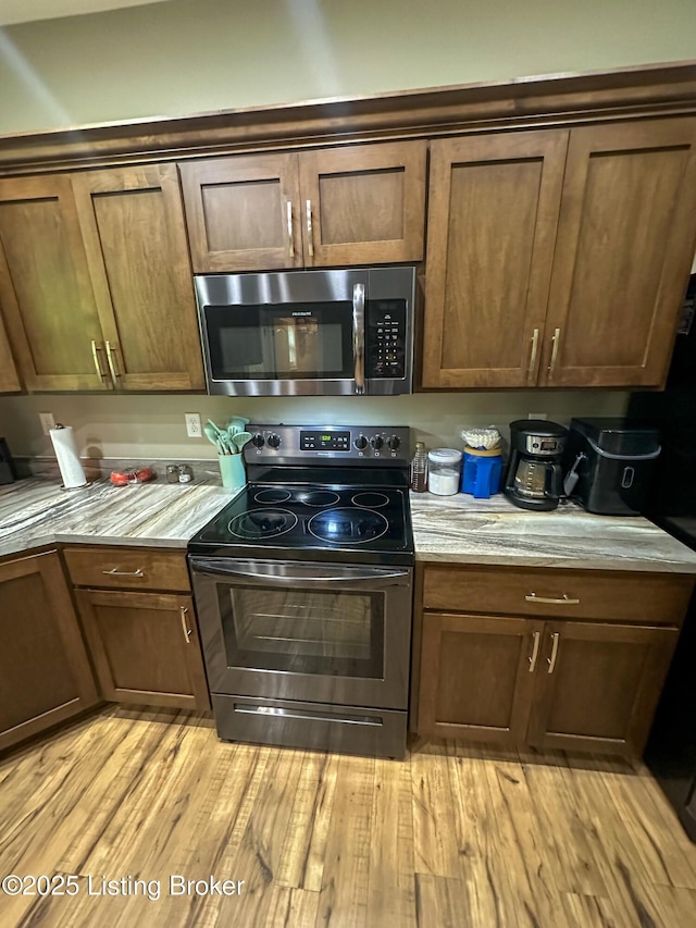kitchen with stainless steel appliances and light wood-type flooring