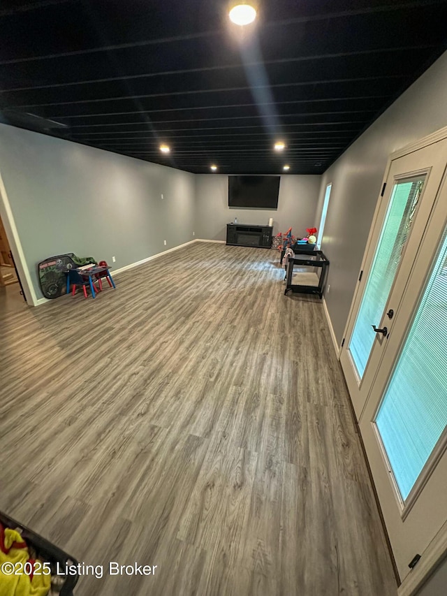 basement featuring wood finished floors, baseboards, and recessed lighting