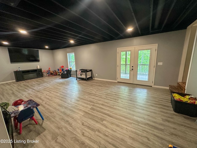 interior space featuring plenty of natural light, wood finished floors, and baseboards