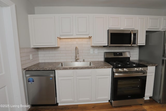 1024 Berry Blvd, Louisville, KY 40215 - kitchen featuring stainless steel appliances, a sink, white cabinetry, and backsplash