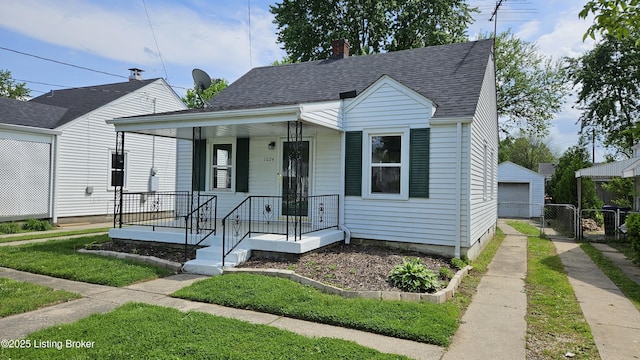 1024 Berry Blvd, Louisville, KY 40215 - bungalow-style home featuring covered porch, a garage, roof with shingles, and a gate
