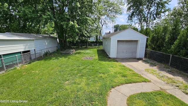 1024 Berry Blvd, Louisville, KY 40215 - view of yard featuring concrete driveway, an outbuilding, and a garage