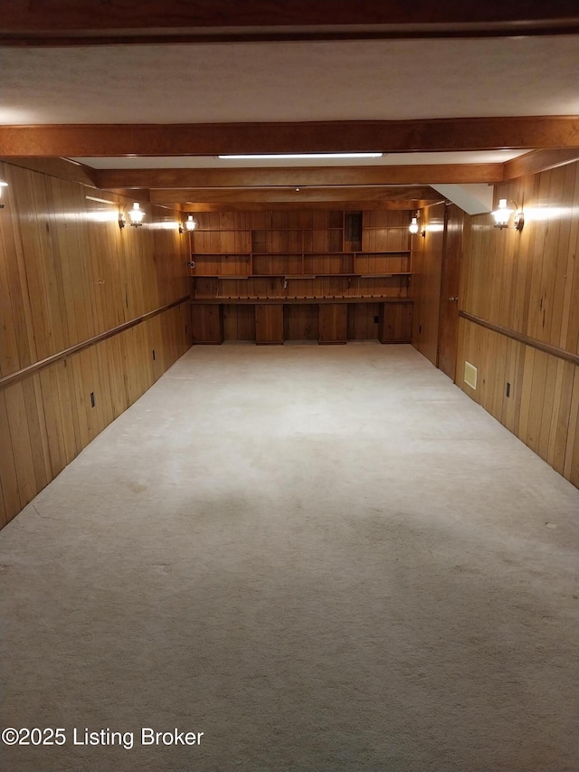 finished below grade area with wooden walls, carpet, and visible vents