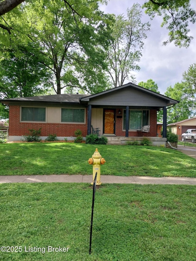 single story home featuring a front yard and brick siding