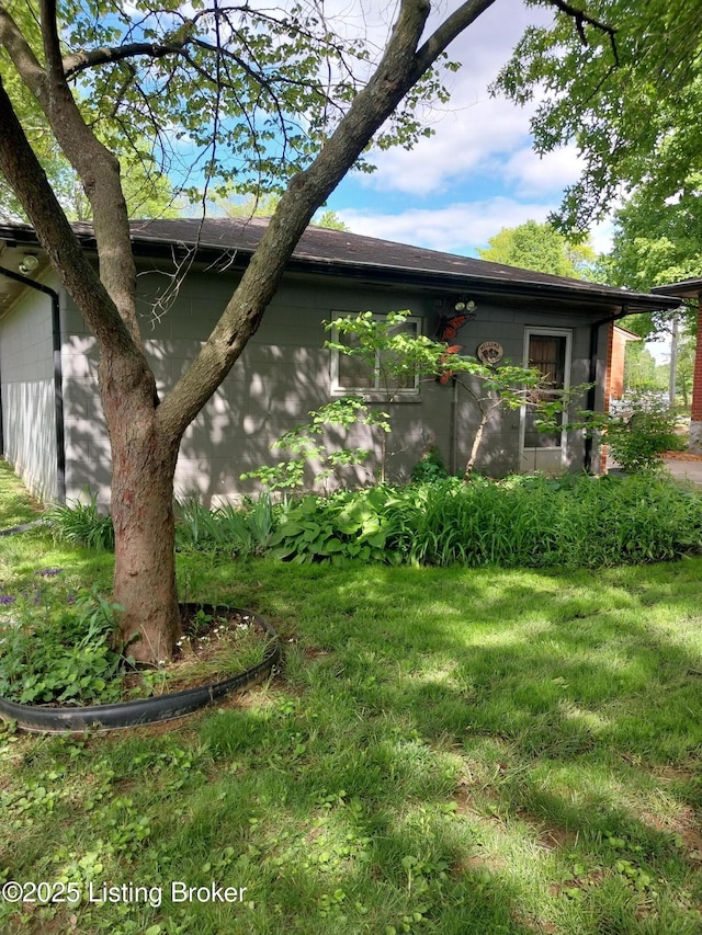 view of home's exterior with a yard