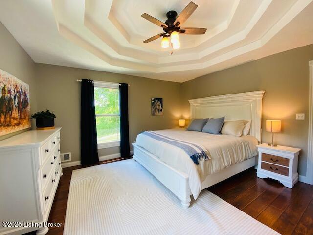 1300 Midway Ln, Springfield, KY 40069 - bedroom featuring a raised ceiling, dark wood-type flooring, a ceiling fan, and baseboards