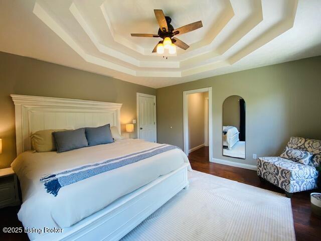 1300 Midway Ln, Springfield, KY 40069 - bedroom with a tray ceiling, wood finished floors, a ceiling fan, and baseboards