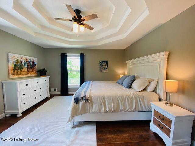 1300 Midway Ln, Springfield, KY 40069 - bedroom with a tray ceiling, dark wood-style floors, and ceiling fan