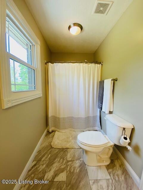 1300 Midway Ln, Springfield, KY 40069 - bathroom with baseboards, toilet, and a shower with curtain