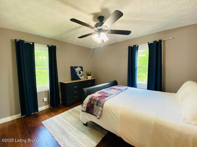 1300 Midway Ln, Springfield, KY 40069 - bedroom with multiple windows, baseboards, dark wood-style flooring, and a ceiling fan