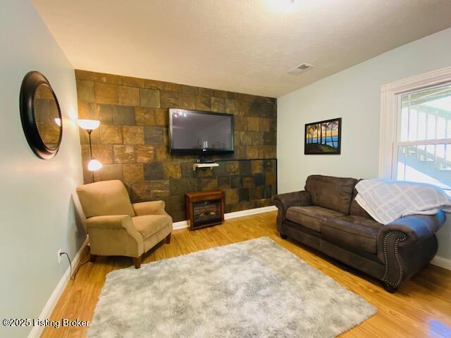 1300 Midway Ln, Springfield, KY 40069 - living area featuring baseboards, light wood finished floors, and an accent wall