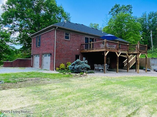 1300 Midway Ln, Springfield, KY 40069 - rear view of house featuring stairs, a deck, a garage, a yard, and brick siding