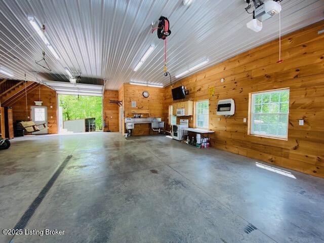 1300 Midway Ln, Springfield, KY 40069 - garage featuring wood walls, heating unit, and a garage door opener