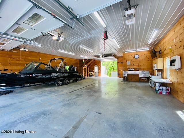 1300 Midway Ln, Springfield, KY 40069 - garage featuring wood walls and a garage door opener