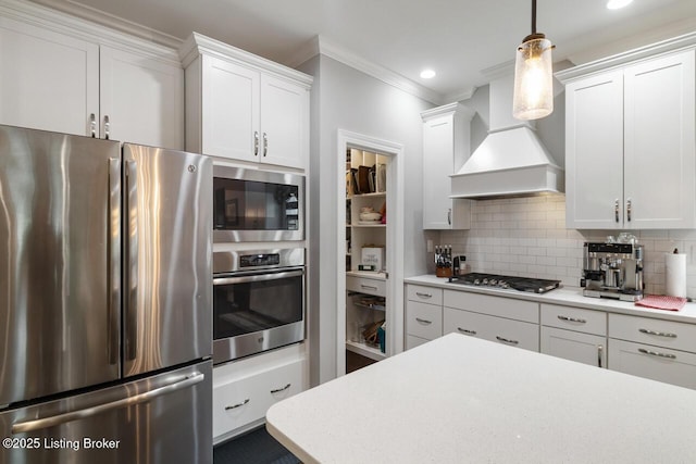 2421 Irish Bend Ct, Fisherville, KY 40023 - kitchen with stainless steel appliances, custom exhaust hood, white cabinetry, light countertops, and ornamental molding