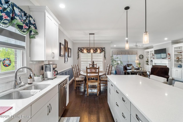 2421 Irish Bend Ct, Fisherville, KY 40023 - kitchen with stainless steel dishwasher, a wealth of natural light, a sink, light countertops, and dark wood-style floors