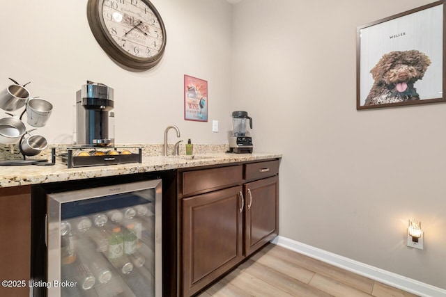 2421 Irish Bend Ct, Fisherville, KY 40023 - bar with wine cooler, bar area, baseboards, a sink, and light wood-style floors