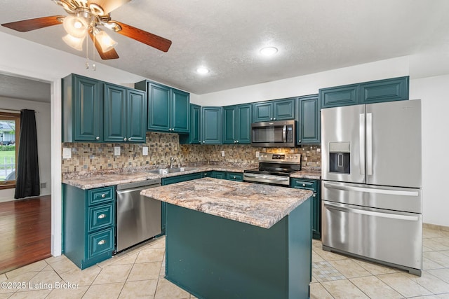 1509 Glenrock Rd, Louisville, KY 40216 - kitchen with appliances with stainless steel finishes, a sink, light tile patterned floors, backsplash, and a textured ceiling