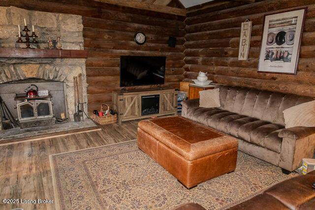 living room featuring rustic walls and wood finished floors