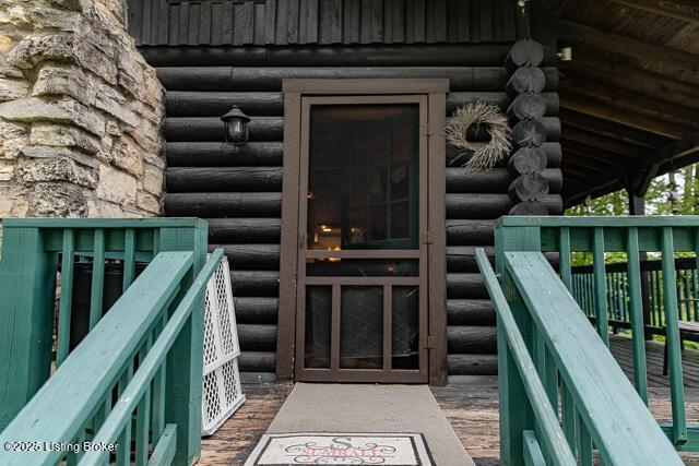 doorway to property with log veneer siding