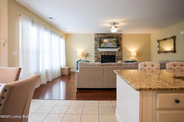 803 Urton Woods Way, Louisville, KY 40243 - tiled living area featuring a ceiling fan and a stone fireplace
